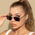 Close-up of model wearing retro square metal sunglasses with gold frames and dark lenses - Gold Frame Grey Lens