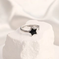 Macro detail of silver adjustable ring featuring a black enamel star on a minimalist band - Adjustable Open / Steel Color Star Black