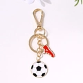 Golden keychain featuring a football pendant and a red sports shoe charm for fans - Gold Soccer Red Shoe Style