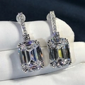 Elegant emerald cut drop earrings with sparkling pavé accents in a silver finish - White Gold