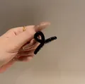 Glossy black 4.5cm jelly hair claw clip with twisted cross design for daily styling - 1 Piece / Black