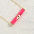 Pink cylinder evil eye pendant necklace in gold finish with white zircon accents - Rose Red