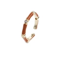 Detail of bamboo joint style adjustable gold ring with brown enamel and zircon stones - Tan