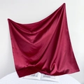 Close-up of elegant burgundy satin silk square scarf with glossy finish and smooth drape - 90*90cm / Rust Red