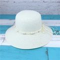Close-up of cream woven straw sun hat featuring decorative wood beads and long tassels - M (56-58cm) / Creamy White