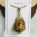 Natural tiger eye stone pendant in golden metal mesh cage with thin gold chain - Gold Tiger Eye