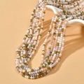 Detail view of 3mm faceted colorful rondelle beads on a multi-strand necklace display - Taro Purple