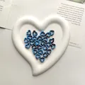 Blue marble effect heart ceramic beads for DIY jewelry making displayed in a tray - Blue with Black Spots