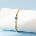 Bracelet élégant en acier inoxydable plaqué or 18 carats avec zircon bleu central - Mars / Aigue-marine