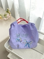 Purple Oxford tote bag with butterfly embroidery and red braided handles in a home setting - Floral Butterfly Purple