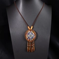 Detail of bohemian beaded necklace with colorful floral pendant and tassels on a bust - X515 Style 8