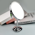 Detail of round double-sided makeup mirror with a chrome metal stand and base - Oval / 5 Inch