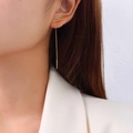 Minimalist 18k gold plated stainless steel line earrings worn by a model in a side view - Gold Ear Threader (F482)