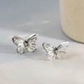 Elegant silver butterfly stud earrings with hollow wings on minimalist background - Single Layer Hollow Style / Silver