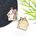 Detailed macro view of enamel house pendant with floral and mushroom motifs - Drip Oil Orange Mushroom Flower House