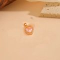 Golden heart pendant featuring a pink center stone and white diamonds on stone display - Gold Pink Zirconia Pendant