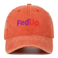 Macro detail of the vintage washed orange cotton fabric and FedUp embroidery on the cap - Orange