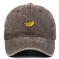 Close-up of embroidered banana pattern on vintage washed dark brown cotton baseball cap - Coffee
