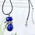 Silver cat pendant necklace featuring blue crystal gems and a black braided rope chain - Lapis Lazuli
