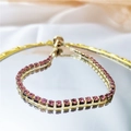 Bracelet doré ajustable orné d'une rangée de zircons violets et roses à coupe carrée - Rose