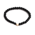 Minimalist matte black stone beaded bracelet with a polished gold heart-shaped charm - Gold Heart Bracelet
