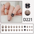 Press-on nail D221 featuring nude pink base, black french tips and 3D bow accent - Nude Pink Black French 3D Bow (D221)