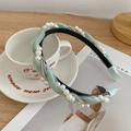 Braided mint green headband with pearl and rhinestone embellishments on fabric - Green