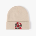 Beige knitted beanie with black slogan embroidery and red lip patterns in street style - Beige