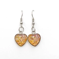 Macro detail of heart-shaped earrings with vibrant orange glitter and silver hooks - Orange (Color 10)
