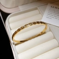 Detail of a gold-plated twisted bangle with inlaid cubic zirconia on a velvet display - Twisted Weave Inlaid Diamond Style (7#)