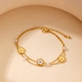 Macro detail of double-layered titanium necklace with floral pendants and white pearls - Pearl Flower