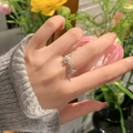 Adjustable silver butterfly ring with double zircons worn on hand with floral background - Double Butterfly Ring