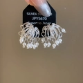 Macro detail of firework-style zircon and pearl ear clips in silver finish - Ear Clips - Eco-friendly - Silver