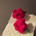Handmade red flocked rose stud earrings with green leaves on a textured paper background - Red