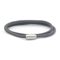 Macro shot of grey woven cord bracelet featuring a magnetic silver metal cylinder clasp - Dark Gray