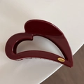 Detailed view of large dark red heart-shaped hair claw with gold Love engraved charm - Heart-Shaped / Red