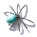 Detailed top view of spider brooch featuring turquoise gemstone and silver metallic legs - Oval Synthetic Turquoise