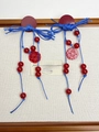 Detail of blue tassels and red Double Happiness charms on festive Chinese style earrings - Blue Cord Red Beaded Earrings / Blue and Red