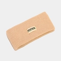 Detail of beige ribbed knit headband featuring an embroidered letter tag with graffiti - One Size / Khaki