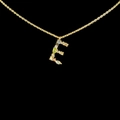 Macro detail of 18k gold letter E pendant with multi-colored gemstones on black background - Letter E [Gold]