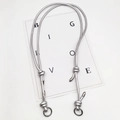 Macro detail of silver braided necklace cord with metal ring connectors and knots - Silver Ring Buckle / Bright Silver