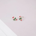 Macro detail of Christmas candy cane stud earrings with green bow and gold plating - Christmas Candy Cane Stud Earrings