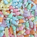 Close-up of colorful resin heart charms with wings for DIY nail art and craft making - Wings Heart