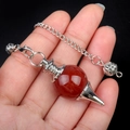 Polished red agate crystal ball pendulum with silver chain and metal base - Red Agate