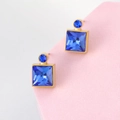 Detail view of square blue crystal earrings with elegant gold-tone metal frame - Blue