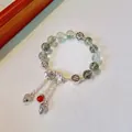 Ethnic beaded bracelet with green phantom quartz and silver lotus tassel charms - Green Ghost: Joyful Lotus Tassel Bracelet
