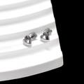 Detail of silver heart-shaped stud earrings on a white minimalist display stand - 3D Heart