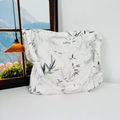 Detail of white floral canvas bag showing black bamboo leaf pattern and woven label text - Ink Bamboo Leaves