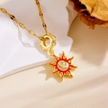 Close-up of golden sun pendant with red enamel rays and sparkling zircon smiley face - Smiling Sun Red Enamel Style (E811)