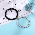 Detail of magnetic couple bracelets with crown charms and natural stone beads - Crown Zirconia Black & White Magnetic Style (Style-05)